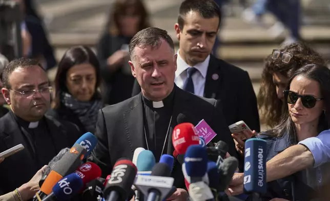 Cardinal Rolandas Makrickas meets the media in front of St. Mary Major Basilica, in Rome, Friday April 25, 2025. (AP Photo/Bernat Armangue)