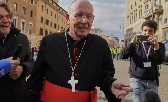 Cardinal Sean Brady is approached by reporters as he arrives for a college of cardinals' meeting, at the Vatican, Monday, April 28, 2025. (AP Photo/Gregorio Borgia)