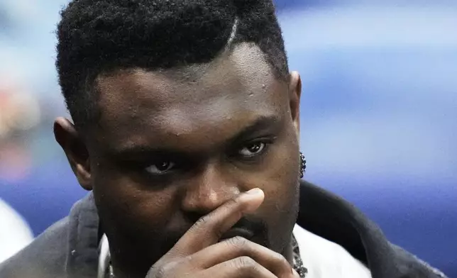 New Orleans Pelicans forward Zion Williamson watches from the bench in street clothes in the first half of an NBA basketball game against the Oklahoma City Thunder in New Orleans, Sunday, April 13, 2025. (AP Photo/Gerald Herbert)