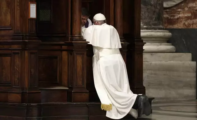 FILE - Pope Francis kneels before a priest to confess, during a penitential liturgy in St. Peter's Basilica at the Vatican, Friday, March 17, 2017. (AP Photo/Andrew Medichini, Pool, File)