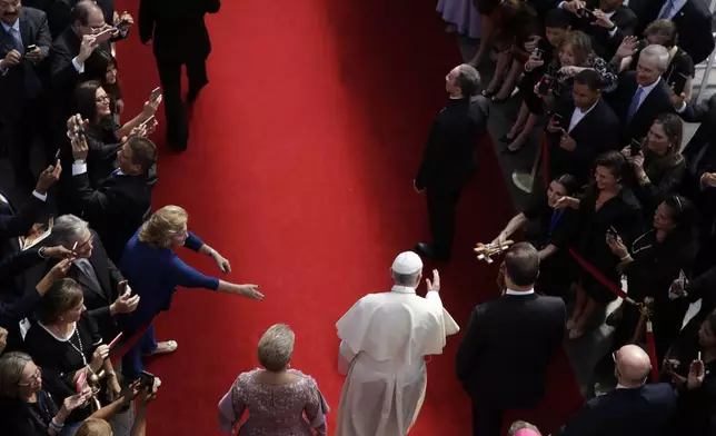FILE - Flanked by Panama's President Juan Carlos Varela, right, and first lady Lorena Castillo, Pope Francis arrives at the foreign ministry headquarters Palacio Bolivar, in Panama City, Thursday, Jan. 24, 2019. (AP Photo/Alessandra Tarantino, file)