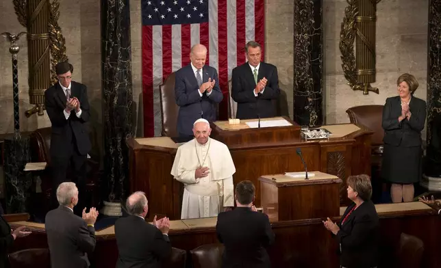 FILE - Pope Francis listens to applause before addressing a joint meeting of Congress on Capitol Hill in Washington, making history as the first pontiff to do so, on Sept. 24, 2015. (AP Photo/Alessandra Tarantino, file)
