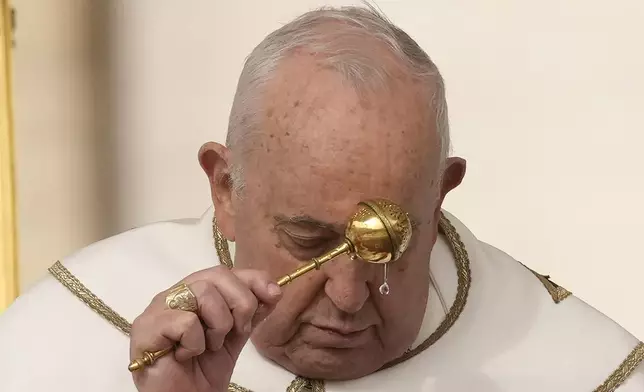 FILE - Pope Francis asperses holy water as he celebrates Easter mass in St. Peter's Square at the Vatican, Sunday, March 31, 2024. (AP Photo/Andrew Medichini, file)
