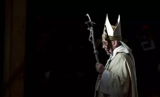 FILE - Pope Francis holds the pastoral staff as he leaves after celebrating a Mass in St. Peter's Basilica, at the Vatican, to mark Epiphany, Monday, Jan. 6, 2014. (AP Photo/Andrew Medichini, file)