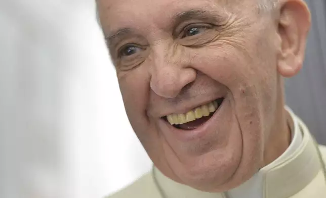 FILE - Pope Francis speaks to journalists during the papal flight direct to Rio de Janeiro, Monday, July 22, 2013. (Luca Zennaro/Pool Photo via AP, File)