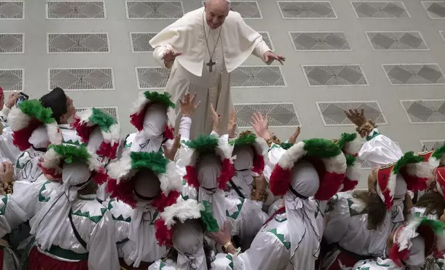 FILE - Pope Francis greets a group of Mexican pilgrims in the Paul VI Hall at the Vatican during his weekly general audience, Wednesday, Dec. 11, 2019. (AP Photo/Alessandra Tarantino, File)