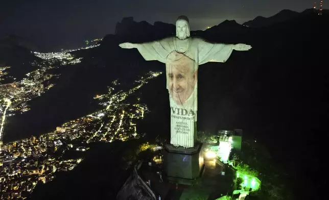The Christ the Redeemer statue is lit up with an image of Pope Francis to mark the launch of his book, "Life: My Story Through History," in Rio de Janeiro, Brazil, Thursday, May 23, 2024. (AP Photo/Silvia Izquierdo, File)