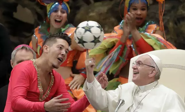 FILE - Pope Francis twirls a soccer ball he was presented by a member of the Circus of Cuba, during his weekly general audience in the Pope Paul VI hall, at the Vatican, Wednesday, Jan. 2, 2019. (AP Photo/Andrew Medichini, file)