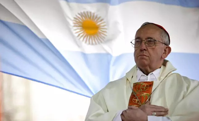 FILE - Argentina's Cardinal Jorge Bergoglio gives a Mass outside the San Cayetano church where an Argentine flag hangs behind in Buenos Aires, Argentina, Friday, Aug. 7, 2009. (AP Photo/Natacha Pisarenko, file)