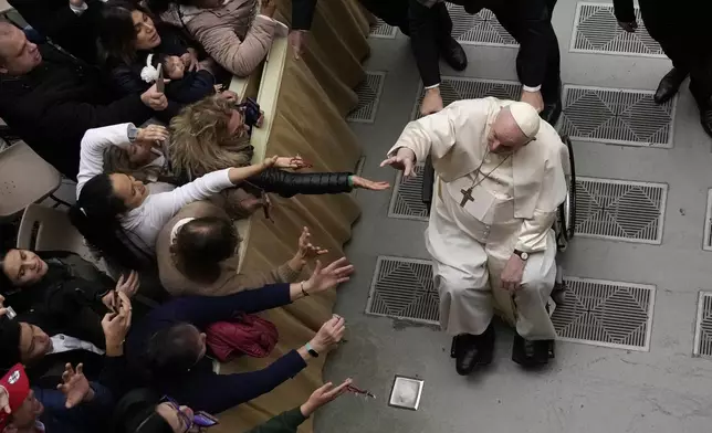 FILE - Pope Francis leaves at the end of his weekly general audience in the Paul VI Hall at the Vatican, Wednesday, Dec. 28, 2022. (AP Photo/Alessandra Tarantino, file)