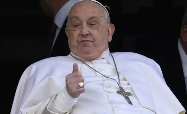 FILE - Pope Francis gives the thumbs up as he appears at a window of the Agostino Gemelli Polyclinic in Rome, Sunday, March 23, 2025, where he has been treated for bronchitis and bilateral pneumonia since Feb. 14. (AP Photo/Domenico Stinellis, File)