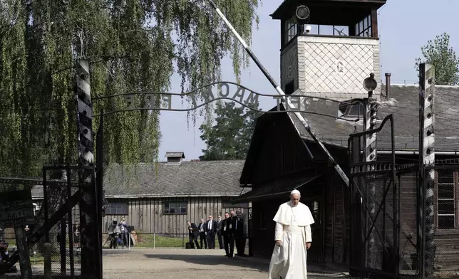 FILE - Pope Francis walks through the gate of the former Nazi German death camp of Auschwitz in Oswiecim, Poland, Friday, July 29, 2016. (AP Photo/Gregorio Borgia, file)