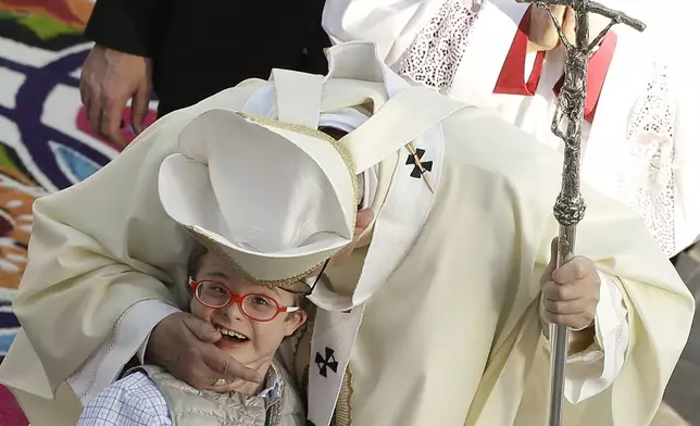 FILE - Pope Francis greets a child as he walks in procession at the Basilica of the Virgin of Guadalupe before celebrating Mass in Mexico City, Feb. 13, 2016. (AP Photo/Gregorio Borgia, File)