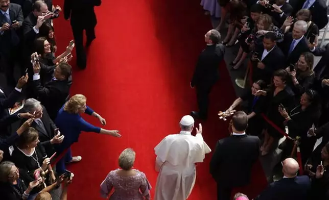 FILE - Flanked by Panama's President Juan Carlos Varela, right, and first lady Lorena Castillo, Pope Francis arrives at the foreign ministry headquarters Palacio Bolivar, in Panama City, Thursday, Jan. 24, 2019. (AP Photo/Alessandra Tarantino, file)
