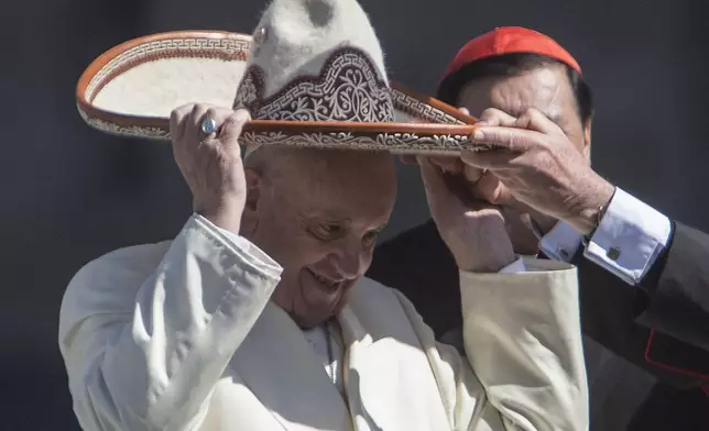 FILE - Pope Francis dons a Mexican charro style sombrero, in Mexico City's main square, the Zocalo, Saturday, Feb. 13, 2016. (AP Photo/Christian Palma, file)