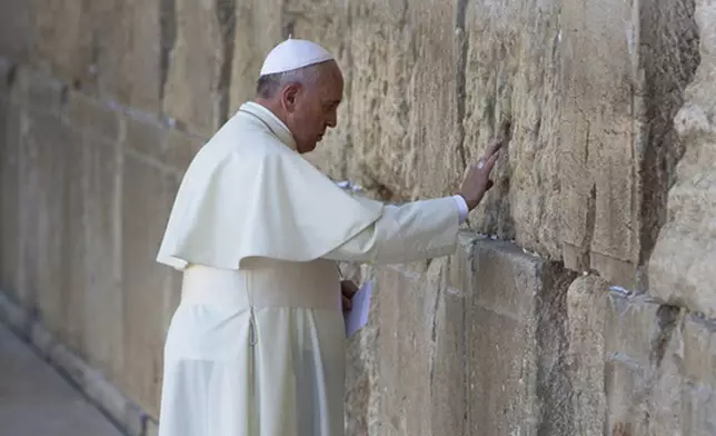 FILE - Pope Francis prays in front of the Western Wall, in Jerusalem's Old City, Monday, May 26, 2014. (AP Photo/Oded Balilty, file)