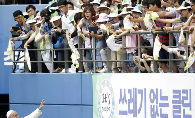 FILE - Pope Francis blesses faithfuls as he arrives to celebrate the Mass of Assumption of Mary at Daejeon World Cup stadium in Daejeon, South Korea, Friday, Aug. 15, 2014. (AP Photo/Gregorio Borgia, file)