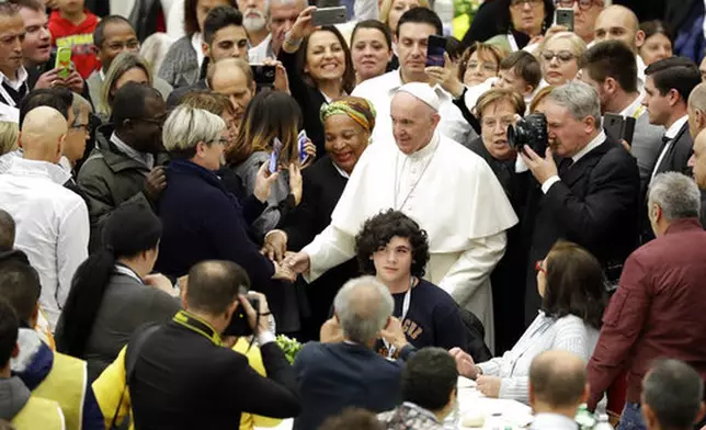 FILE - Pope Francis greets people as he arrives at a lunch for the poor, homeless, migrants and unemployed, at the Vatican, Sunday, Nov. 18, 2018. (AP Photo/Andrew Medichini, file)