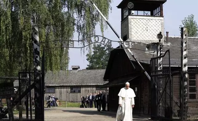 FILE - Pope Francis walks through the gate of the former Nazi German death camp of Auschwitz in Oswiecim, Poland, Friday, July 29, 2016. (AP Photo/Gregorio Borgia, file)