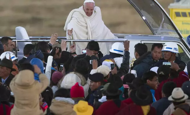 FILE - Pope Francis waves from the popemobile after arriving to El Alto International airport in El Alto, Bolivia, Wednesday, July 8, 2015. (AP Photo/Eduardo Verdugo, file)
