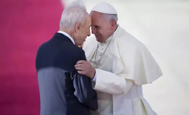 FILE - Pope Francis, right, talks with Israeli President Shimon Peres, during an official arrival ceremony at Ben Gurion airport near Tel Aviv, Israel, Sunday, May 25, 2014. (AP Photo/Oded Balilty, file)