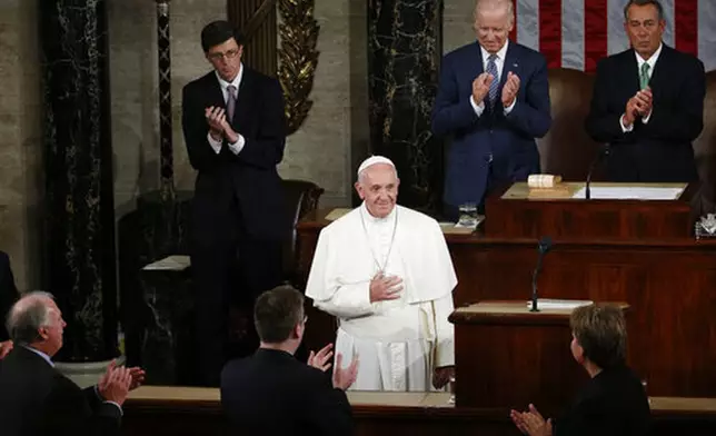 FILE - US Vice President Joe Biden, second from right at top, and House Speaker John Boehner of Ohio and others applaud Pope Francis as he arrives to address a joint meeting of Congress on Capitol Hill in Washington, making history as the first pontiff to do so, Thursday, Sept. 24, 2015. (AP Photo/Carolyn Kaster, file)