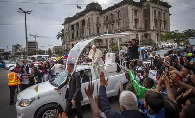 FILE - Pope Francis waves to well wishers as he leaves after a meeting at the Cathedral of the Immaculate Conception in the capital Maputo, Mozambique, Thursday, Sept. 5, 2019. (AP Photo/Ben Curtis, file)