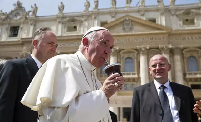 FILE - Pope Francis drinks from a mate gourd, a traditional South American cup, at the end of his weekly general audience, in St. Peter's Square at the Vatican, Wednesday, April 6, 2016. (AP Photo/Andrew Medichini, file)