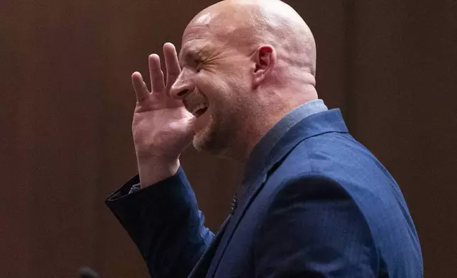 Shelby County deputy district attorney Paul Hagerman gestures to his head while discussing Tyre Nichol's head injuries as he gives the prosecution's opening statement during the first day of the state criminal trial for the death of Nichols at 201 Poplar in Memphis, Tenn., on Monday, April 28, 2025. (Chris Day/Commercial Appeal/USA Today Network, via AP, Pool)