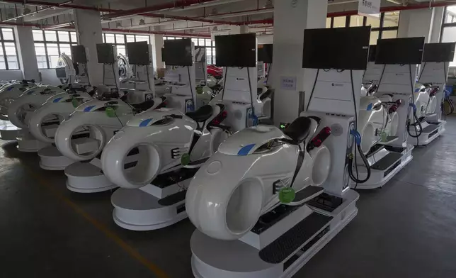 Completed virtual reality gaming platforms are covered up at the factory of Zhuoyuan Tech Co., Ltd in Panyu district of Guangzhou city in southern China's Guangdong province on Wednesday, April 16, 2025. (AP Photo/Ng Han Guan)