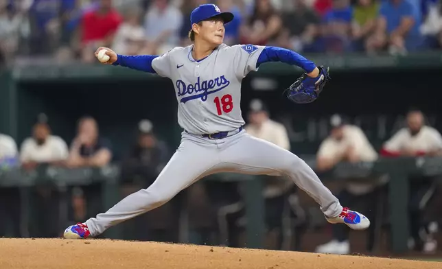 Los Angeles Dodgers starting pitcher Yoshinobu Yamamoto throws a pitch to the Texas Rangers during the second inning of a baseball game Friday, April 18, 2025, in Arlington, Texas. (AP Photo/Julio Cortez)