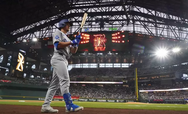 Los Angeles Dodgers' Tommy Edman walks to the plate to leadoff the first inning of a baseball game against the Texas Rangers Friday, April 18, 2025, in Arlington, Texas. (AP Photo/Julio Cortez)