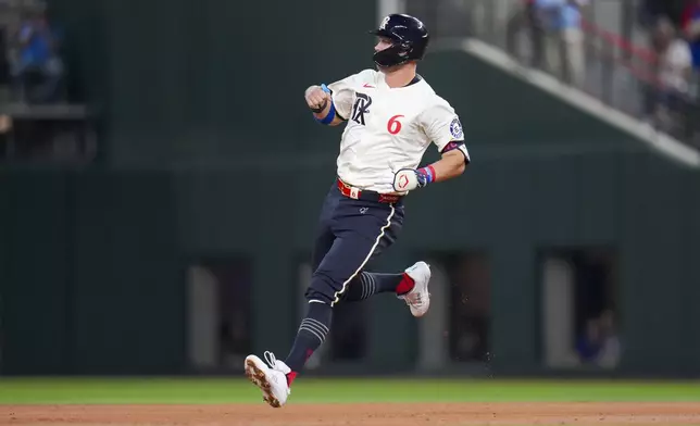 Texas Rangers' Josh Jung reaches second on a double off Los Angeles Dodgers starting pitcher Yoshinobu Yamamoto during the second inning of a baseball game Friday, April 18, 2025, in Arlington, Texas. (AP Photo/Julio Cortez)