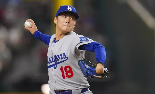 Los Angeles Dodgers starting pitcher Yoshinobu Yamamoto throws a pitch to the Texas Rangers during the first inning of a baseball game Friday, April 18, 2025, in Arlington, Texas. (AP Photo/Julio Cortez)
