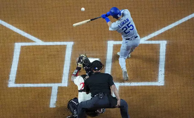 Los Angeles Dodgers' Tommy Edman (25) connects for a leadoff home run on the second pitch of the game by Texas Rangers starting pitcher Jacob deGrom during the first inning of a baseball game Friday, April 18, 2025, in Arlington, Texas. (AP Photo/Julio Cortez)