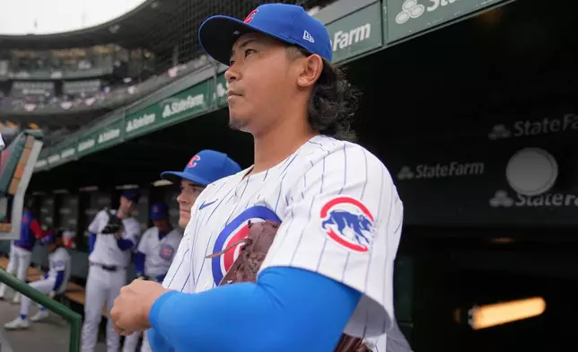 Chicago Cubs starting pitcher Shota Imanaga (18) stands in the dugout before a baseball game against the San Diego Padres, Friday, April 4, 2025, in Chicago. (AP Photo/Erin Hooley)