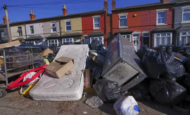 Rubbish piles up on a residential street in Birmingham, England, Monday, April 7, 2025, amid an ongoing refuse workers' strike in the city. (AP Photo/Kirsty Wigglesworth)