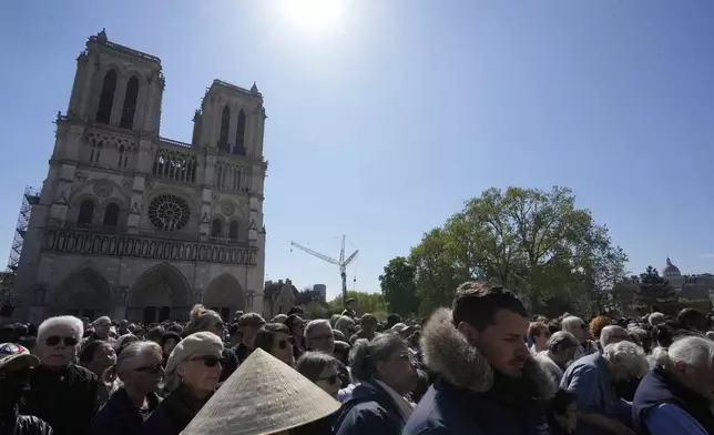 People attend the Way of Cross ceremony to mark Good Friday at Notre Dame cathedral, Friday, April 18, 2025 in Paris. (AP Photo/Michel Euler)