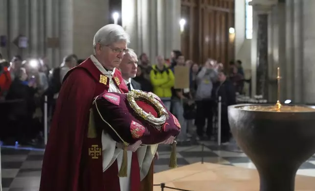 Paris Archbishop Laurent Ulrich holds the ancient relic that many Christians revere as Jesus Christ's "Crown of Thorns" during a ceremony to mark Good Friday at Notre Dame cathedral, Friday, April 18, 2025 in Paris. (AP Photo/Michel Euler)
