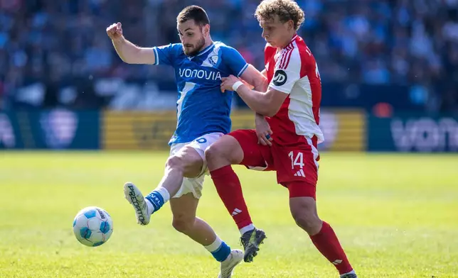 Bochum's Matus Bero, left, and Berlin's Leopold Querfeld, right, challenge for the ball during the German Bundesliga soccer match between VfL Bochum and 1. FC Union Berlin in Bochum, Germany, Sunday, April 27, 2025. (David Inderlied/dpa via AP)