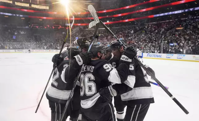 Los Angeles Kings left wing Andrei Kuzmenko (96) celebrates his goal with teammates during the second period in Game 2 of an NHL hockey first-round playoff series Edmonton Oilers, Wednesday, April 23, 2025, in Los Angeles. (AP Photo/Mark J. Terrill)
