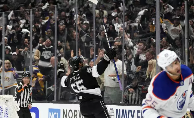 Los Angeles Kings right wing Quinton Byfield celebrates his goal as Edmonton Oilers defenseman Darnell Nurse skates away during the second period in Game 2 of an NHL hockey first-round playoff series Wednesday, April 23, 2025, in Los Angeles. (AP Photo/Mark J. Terrill)