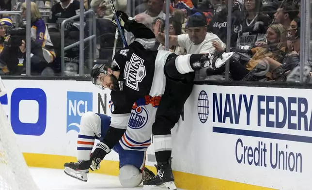 Los Angeles Kings defenseman Drew Doughty, right, collides with Edmonton Oilers right wing Vasily Podkolzin during the first period in Game 2 of an NHL hockey first-round playoff series Wednesday, April 23, 2025, in Los Angeles. (AP Photo/Mark J. Terrill)