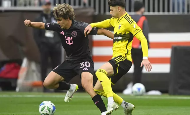 Inter Miami midfielder Benjamin Cremaschi (30) controls the ball beside Columbus Crew forward Max Arftsen, right, during the first half of an MLS soccer match Saturday, April 19, 2025, in Cleveland, Ohio. (AP Photo/David Richard)