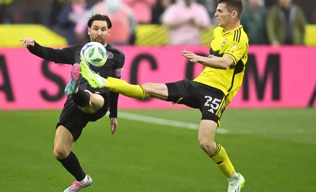 Inter Miami CF forward Lionel Messi, left, and Columbus Crew midfielder Sean Zawadzki kick for the ball during the second half of an MLS soccer match on Saturday, April 19, 2025, in Cleveland, Ohio. (AP Photo/David Richard)