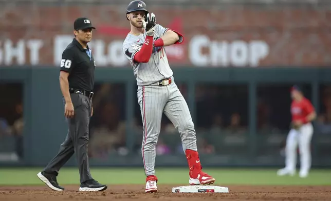 Minnesota Twins catcher Ryan Jeffers (27) celebrates after driving in a run in the second inning of a baseball game against the Atlanta Braves, Friday, April 18, 2025, in Atlanta. (AP Photo/Colin Hubbard)