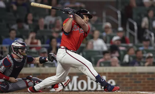 Atlanta Braves' Drake Baldwin, right, hits a game-winning pinch hit single in the eighth inning of a baseball game against the Minnesota Twins, Friday, April 18, 2025, in Atlanta. (AP Photo/Colin Hubbard)