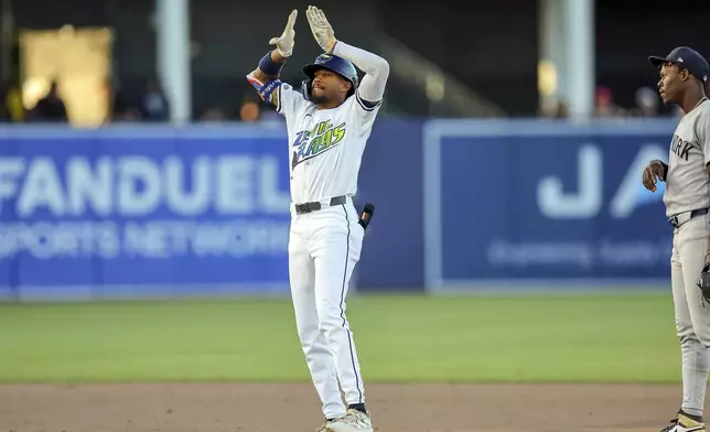 Tampa Bay Rays' Chandler Simpson celebrates after his first major league hit, a ground rule double, in his debut during the ninth inning of a baseball game against the New York Yankees, Saturday, April 19, 2025, in Tampa, Fla. (AP Photo/Mike Carlson)
