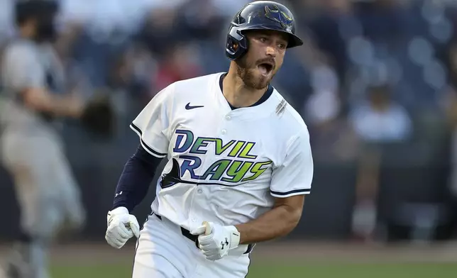 Tampa Bay Rays' Brandon Lowe celebrates after hitting a single that scored two runs during the ninth inning of a baseball game against the New York Yankees, Saturday, April 19, 2025, in Tampa, Fla. (AP Photo/Mike Carlson)