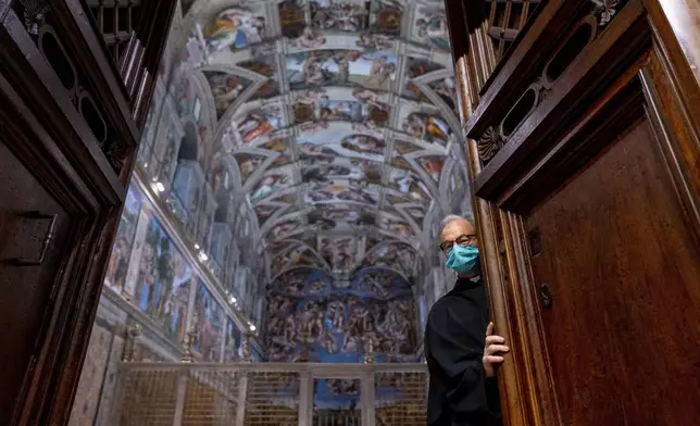 Custodian of the Apostolic Shrine Padre Bruno Silvestrini closes the doors to the Sistine Chapel at the Vatican in Rome, June 28, 2021. (AP Photo/Andrew Harnik, Pool)